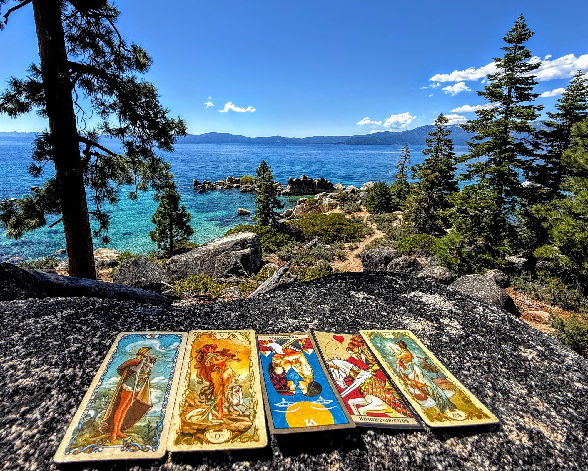 Tarot cards on a granite boulder overlooking Lake Tahoe