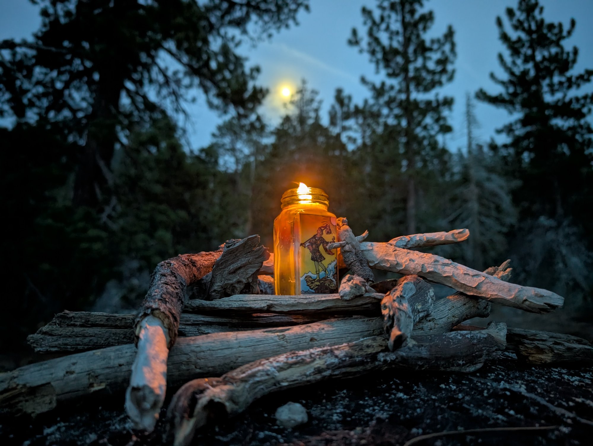 The Fool candle burning under the moonrise at Lake Tahoe